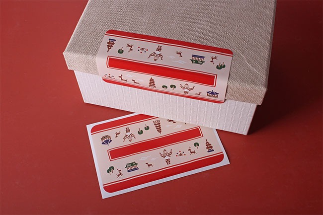 Small business owner sealing a gift box as their holiday marketing strategy